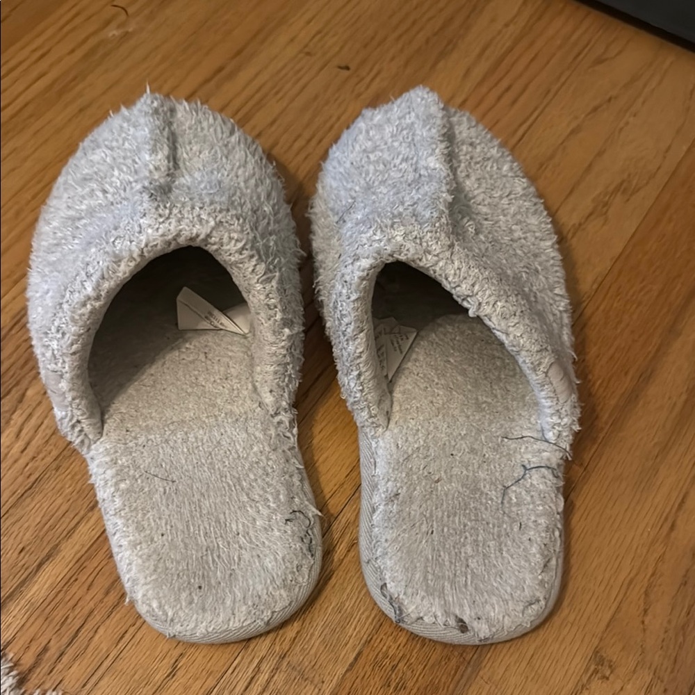 Well worn Barefoot Dreams slippers
